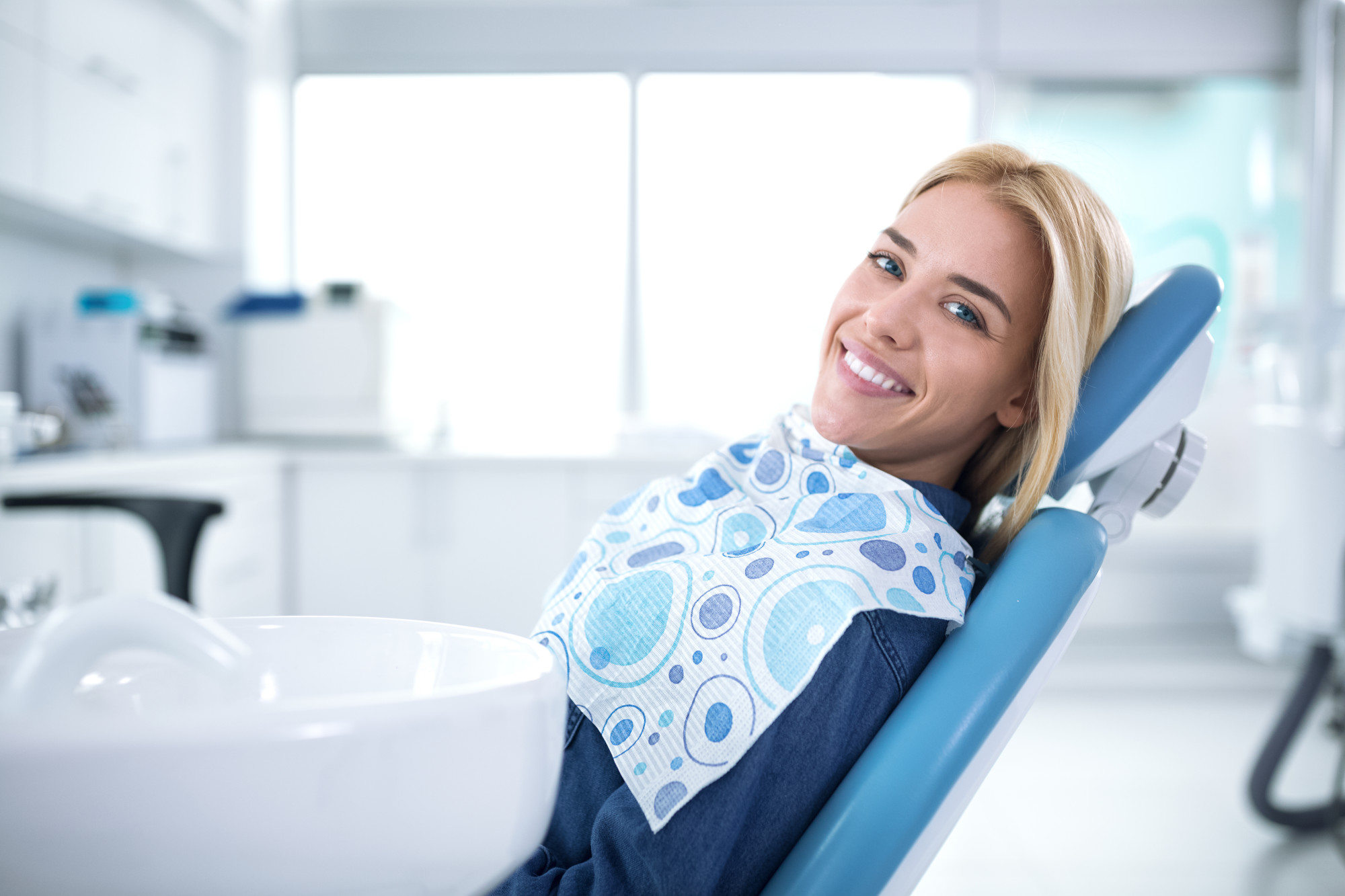 woman getting a teeth cleaning at the dentist